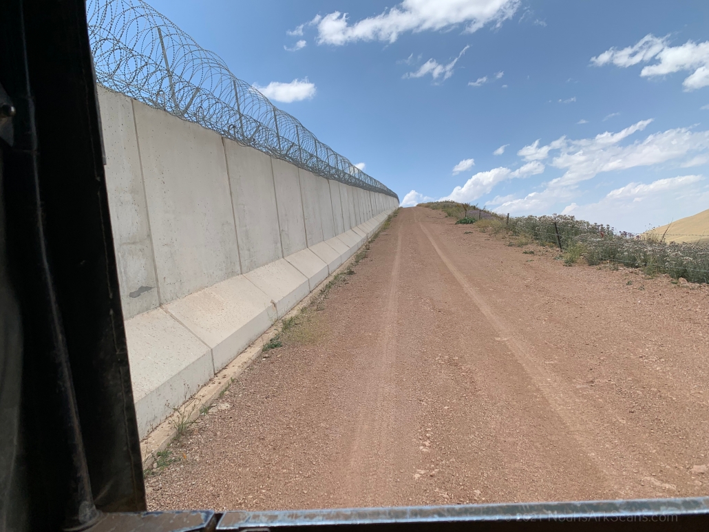 Driving in the back of a Turkish military truck along the Turkish-Iranian border. This is the new wall that they built on the Turkish side.